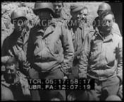 [WWII - 1944 ca, German Newsreel w/ tank action; captured USAAF crew in POW camp; German bombs loaded]nGerman infantry in field fighting; antiaircraft guns fire on US fighter bomber, crashes.n00:00:18t05:09:37German tankscivilians evacuatedthey read, smile.CUs.n00:03:41t05:13:00German General Eugen Meindl, paratrooper commander, meets German officers in northern France.Officer giving directions to German troops in town street.n00:04:14t05:13:33CU direction sign to Saint-Lo 12.2km.