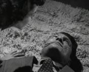 A giant with a scarred face crashes into an apartment, then confronts a couple on the couch. He tosses the man aside, then strangles the woman, who frantically gestures that there&#39;s a gun in her desk. The young man shoots the huge attacker, who collapses, blood dripping from his mouth. The woman urges the young man to get out - she&#39;ll dispose of the body. After he leaves, the giant sits up and breaks into a huge grin. Peter Gunn is summoned by the District Attorney to find the beautiful woman, b