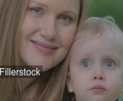 Slow motion and close-up shot of family outdoor. Portrait of happy mother and cute little child with big blue eyes. Mom kissing the boynLicense this clip: https://fillerstock.com/video/5689