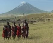 A group of Massai warriors (Moran) in Tanzania are dancing and singing in traditional way. In background you see Ol Doinyo Lenagi, the Mountain of God