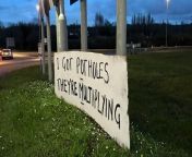 A mysterious artist, dubbed the Daventry Banksie, has left a series of signs in Northamptonshire mocking West Northamptonshire Council for the number of potholes on the roads. &#60;br/&#62; &#60;br/&#62; Report by Ajagbef. Like us on Facebook at http://www.facebook.com/itn and follow us on Twitter at http://twitter.com/itn