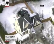 Icy conditions in Wake County, North Carolina led an SUV to slide down a driveway, through a garage and into a backyard pool on Monday